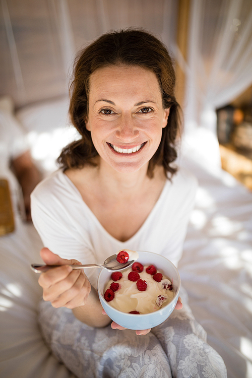 Portrait of happy woman having breakfast during morning