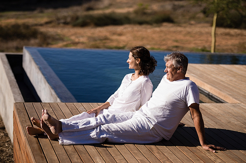 Couple relaxing on wooden plank on a sunny day