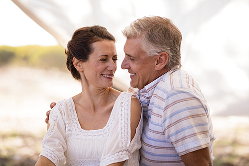 Happy couple sitting in cottage during safari vacation