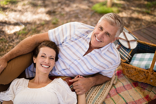 Portrait of happy couple relaxing in cottage during safari vacation