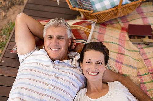 Portrait of happy couple relaxing in cottage during safari vacation