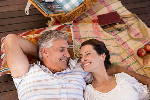 Happy couple relaxing in cottage during safari vacation