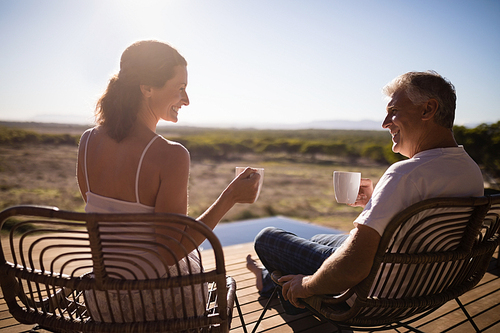 Senior couple having coffee while sitting at the resort