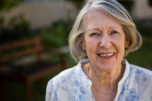 Close up portrait of happy senior woman at park