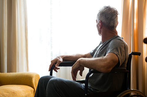 senior man looking away while sitting on . in nursing home