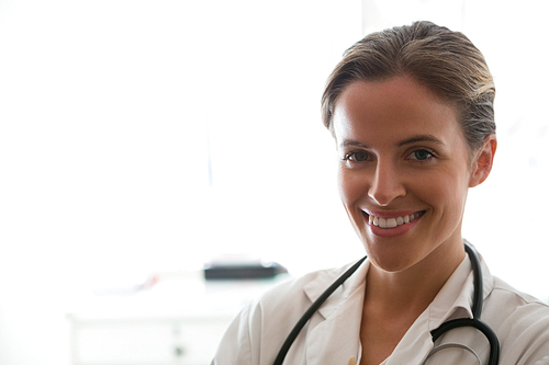 Portrait of confident female doctor standing in nursing home