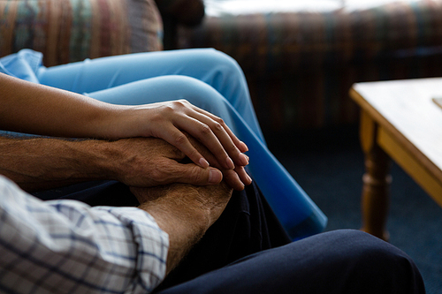 Cropped image of female doctor consoling senior man in nursing home