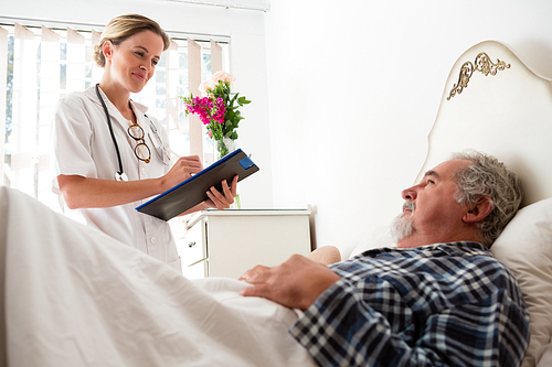 Female doctor examining male patient in nursing home