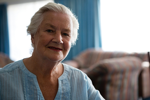 Portrait of smiling senior woman sitting in nursing home