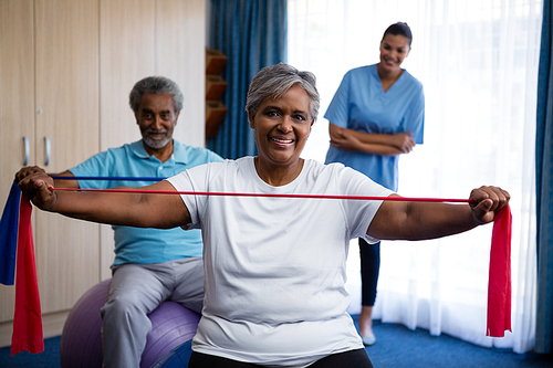 Nurse training seniors in exercising at nursing home