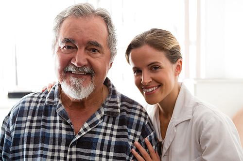 Portrait of smiling female doctor with senior patient in nursing home