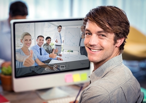 Businessman having video call with colleagues on desktop computer at office