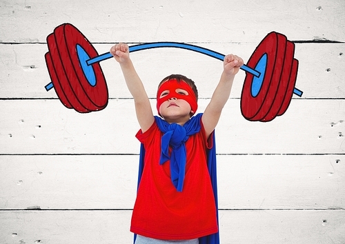 Digital composition of boy in superhero costume pretending to lift weights against wooden background