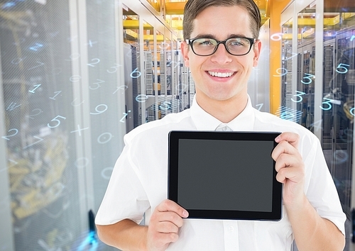 Digital composition of man holding digital tablet against server room in background