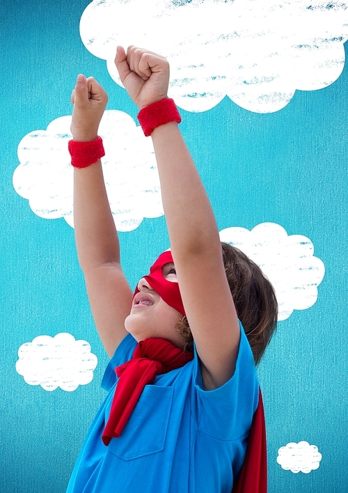 Digital composition of boy in superhero costume pretending to fly against clouds in background