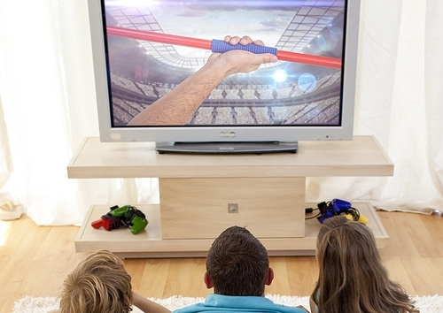 Rear view of family watching javelin throw on television at home