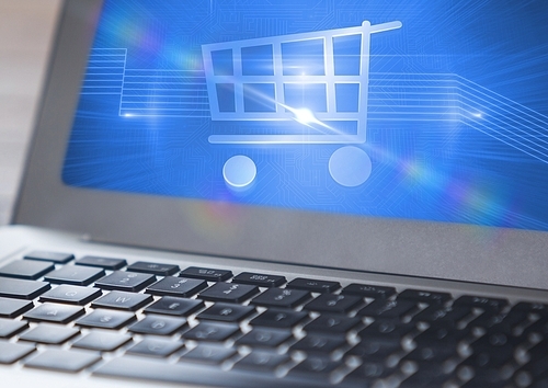 Close-up of shopping cart symbol on laptop
