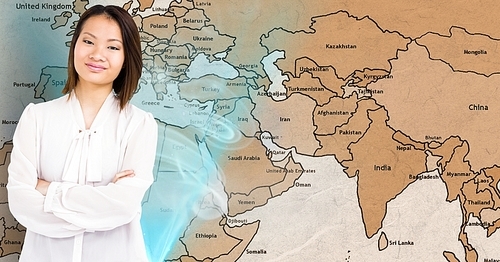 Digital composite of smiling woman standing with arms crossed against world map