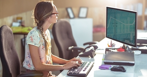 Female graphics designer using computer in office