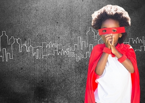 Portrait of super kid in red cape and red mask against sketch background