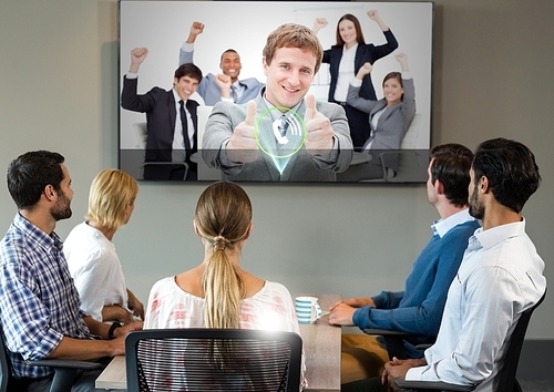 Businesspeople having video calling on television in office
