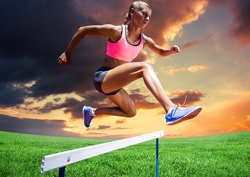Digital composite of athlete woman jumping over hurdle against cloudy sunset