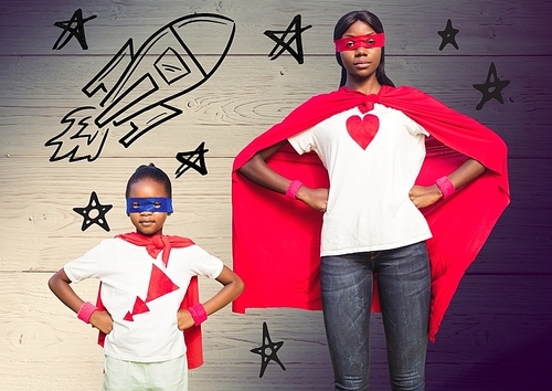 Digitally composite of mother and daughter wearing red cape and mask against wooden background