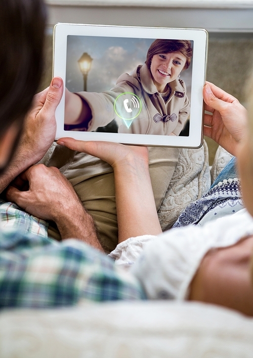 Couple having video chat on digital tablet at home