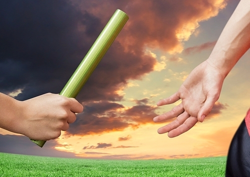 Digital composite of athlete passing the baton to teammate against dramatic sunset background