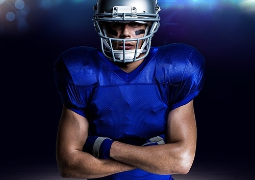 Digital composite of american player in helmet standing with arms crossed