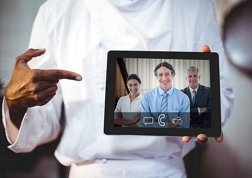 Mid section of businessman having video call with colleagues on digital tablet