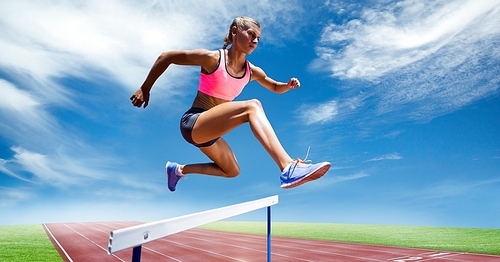 Digital composite image of female athlete jumping above the hurdle against sky background