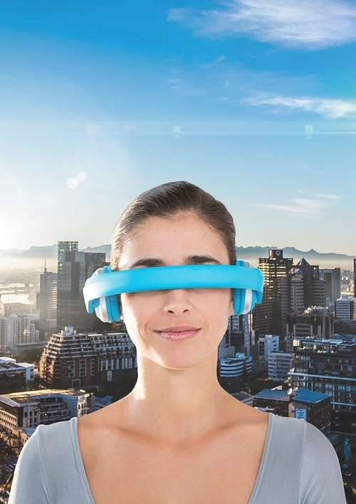 Digital composite image of woman using virtual reality headset against cityscape background