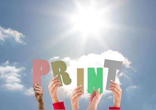 Digitally composite image of hands holding word Print against bright sunlight