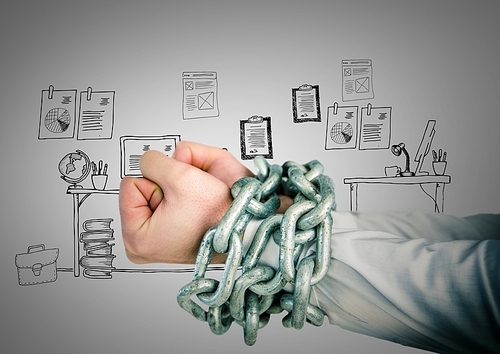 Digitally composite image of businessman hands bound in chains against office