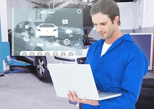 Digital composition of mechanic using laptop against car mechanics interface in background
