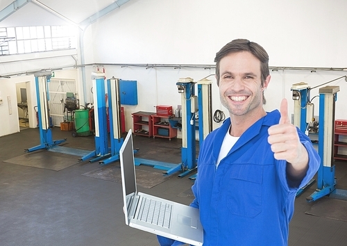 Digital composition of mechanic with laptop showing thumbs up against garage in background