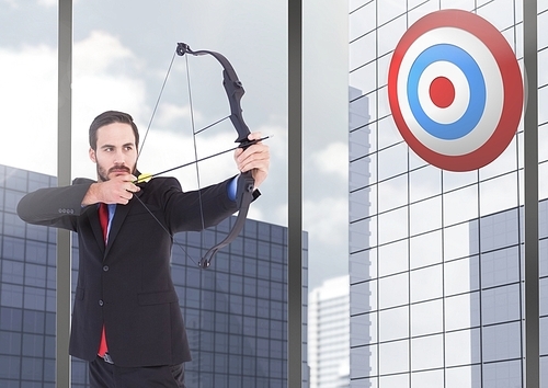 Digital composition of businessman aiming at the target board against office buildings in background