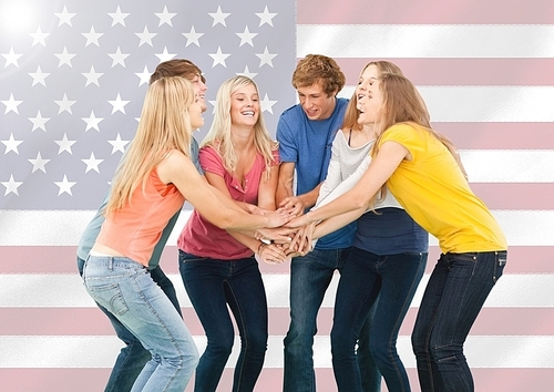 Digital composition of friends with their hands stacked against american flag in background