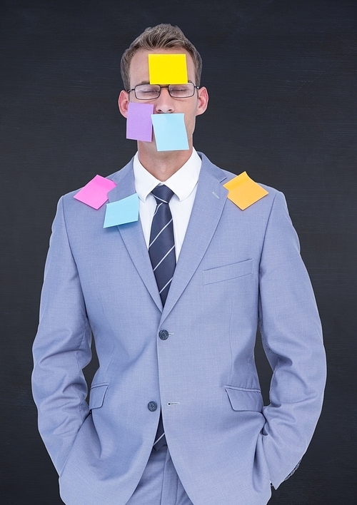 Businessman with sticky notes stuck on his face against black background