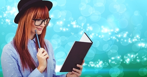 Smiling woman reading a book against digitally generated background