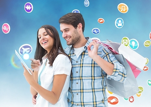 Digital composition of happy man holding shopping bags and woman using digital tablet with various icons in background