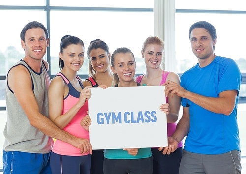 Digital composition of happy people holding blank placard in gym