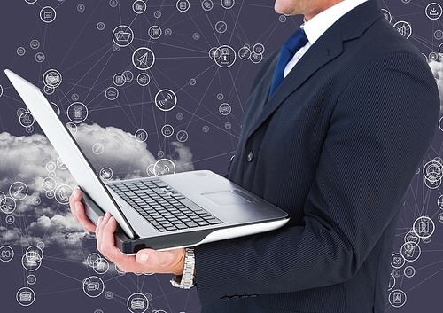 Digital composition of businessman holding laptop with connecting icons and cloud in background