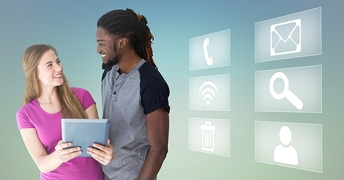 Digital composition of happy man and woman holding digital tablet and various application icons in background
