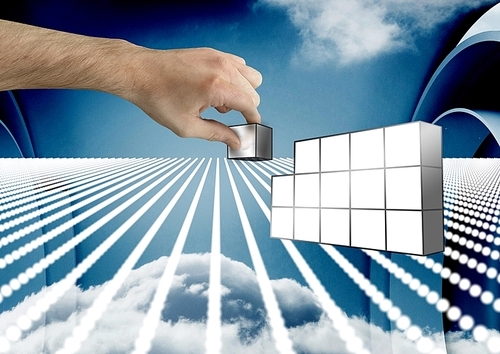 Digital composite of Hand holding futuristic blocks against sky