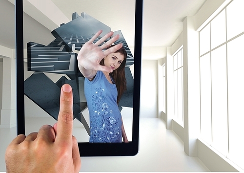 Digital composite of Hand Touching tablet screen with virtual reality