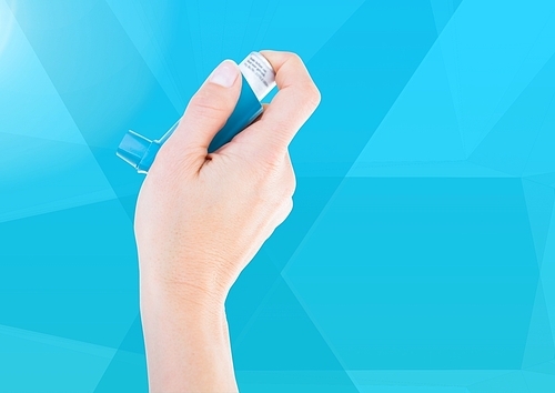 Digital composite of Hand holding Ashtma Inhaler against blue background