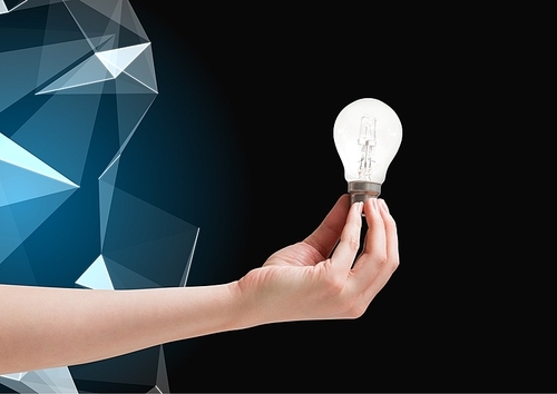 Digital composite of Hand holding Lightbulb against graphic polygon in background