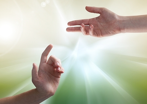 Digital composite of Hands against illuminated green background